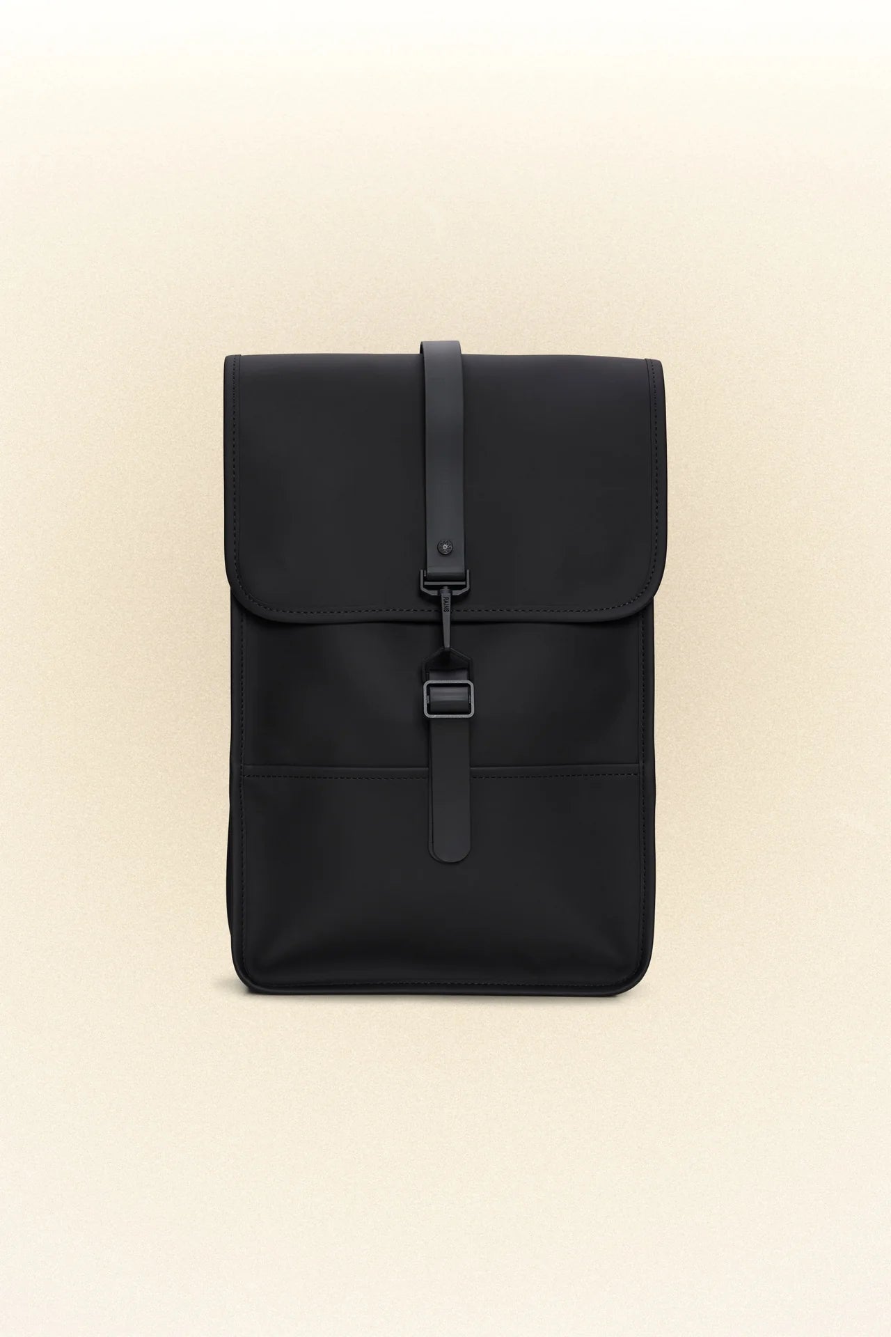 A black Rains mini backpack on a white background.