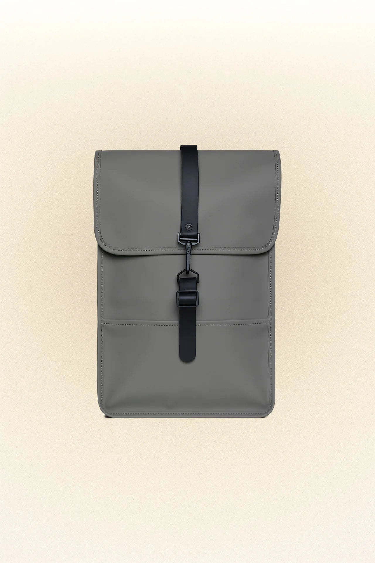 A Rains Backpack Mini with black straps and a laptop pocket, on a white background.