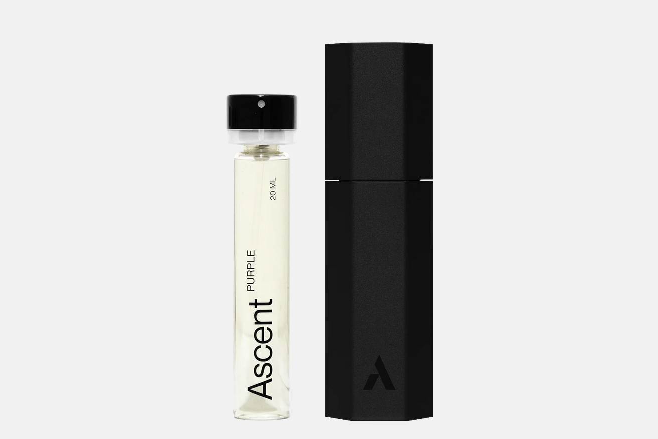 An Ascent Starter Pack - Purple 20 ml glass spray vial of perfume extract standing next to a black hexagonal cylindrical container.