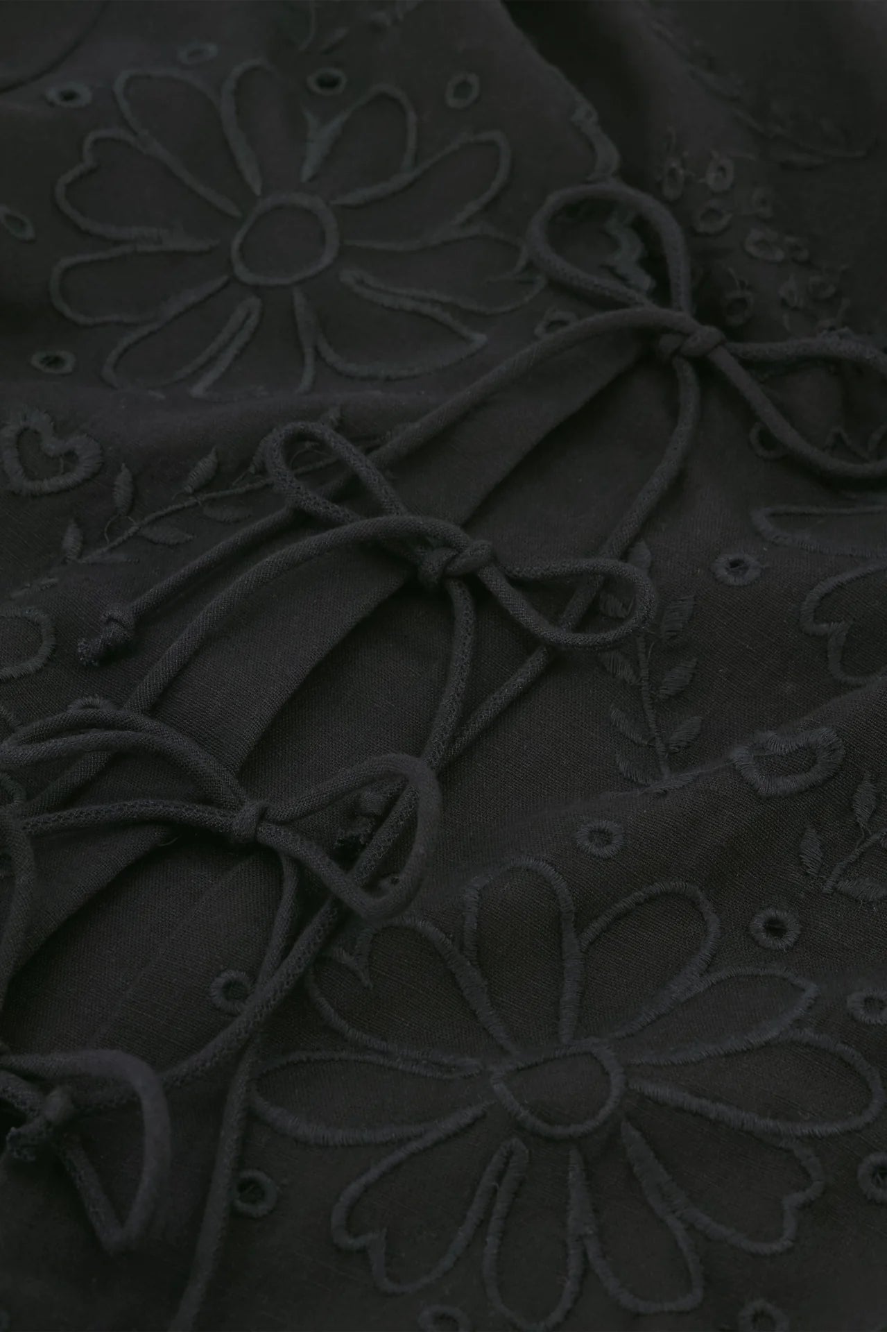 A close up of the Fabienne Chapot Sterre Top - Black embroidered with flowers.