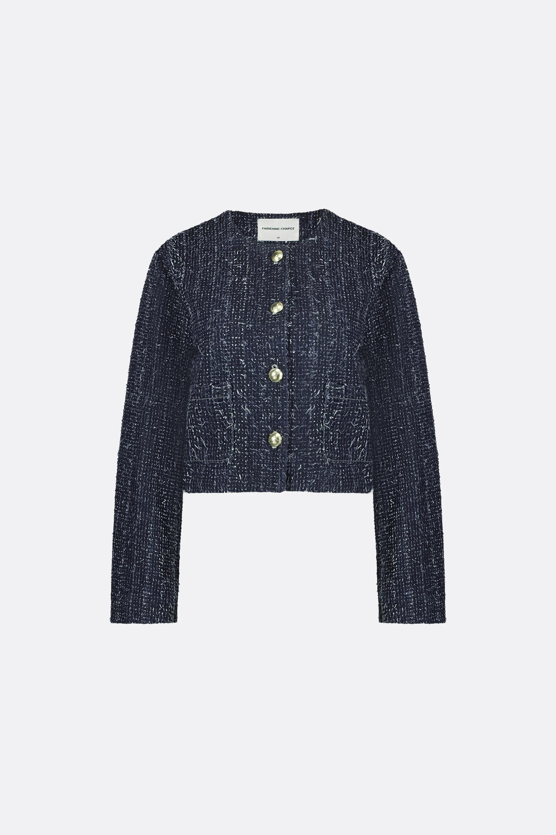 The Davis Blazer by Fabienne Chapot is a denim, textured button-up jacket featuring long sleeves and a round neckline.