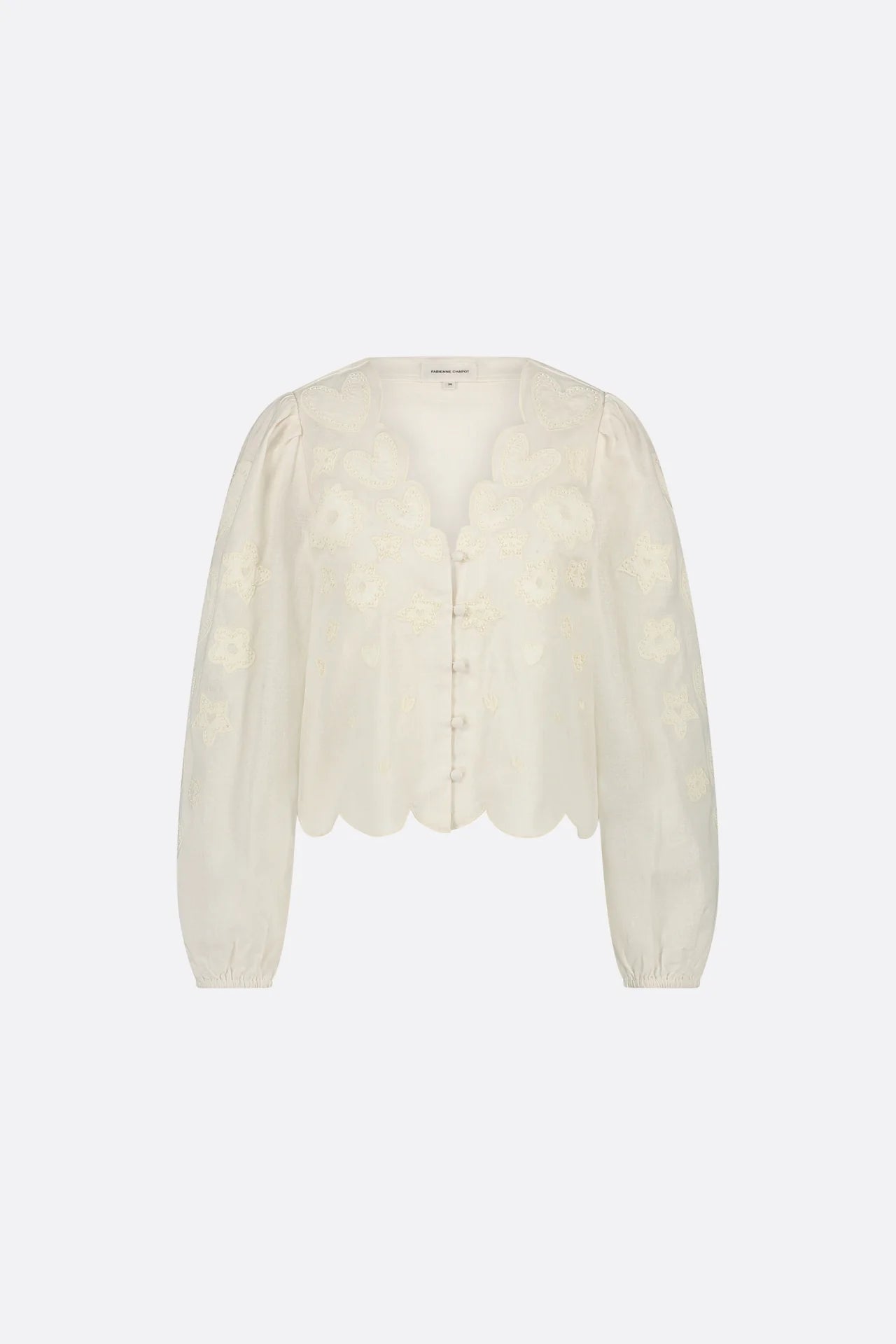 The Rani Blouse - Cosy White by Fabienne Chapot showcases long sleeves, scalloped edges, and delicate floral embroidery. It's crafted from an organic blend with elegantly placed buttons down the front.