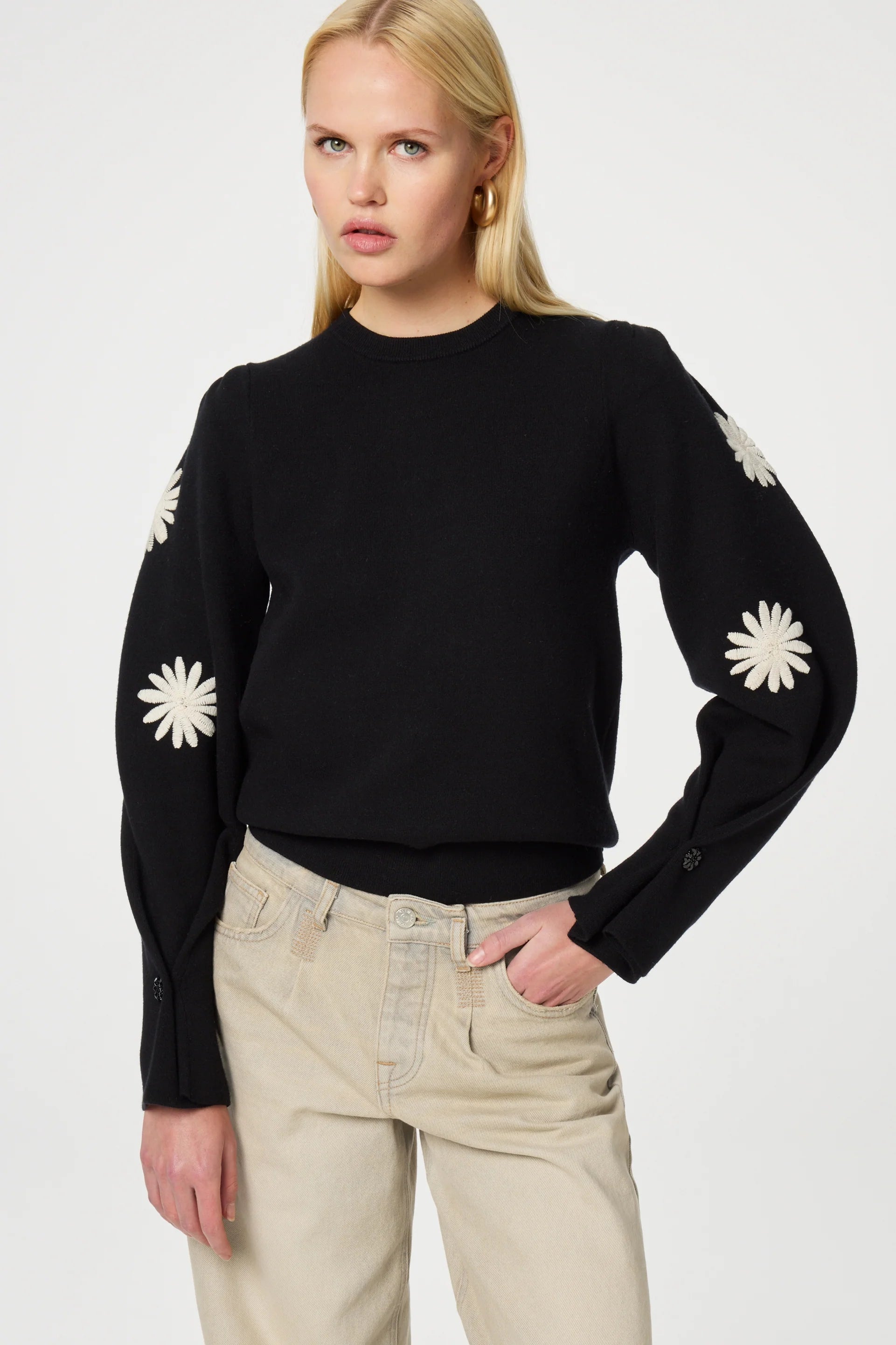 The Biba Pullover - Black by Fabienne Chapot features elegant white flower embroidery along the sides of the sleeves, making it an ideal choice for a smart casual look.