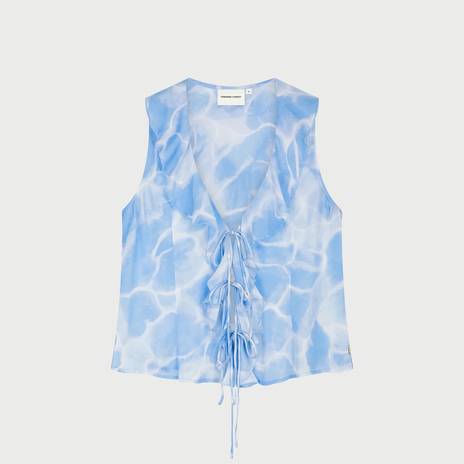 Blue tie-dye water print sleeveless top by fabienne chapot on a light gray background