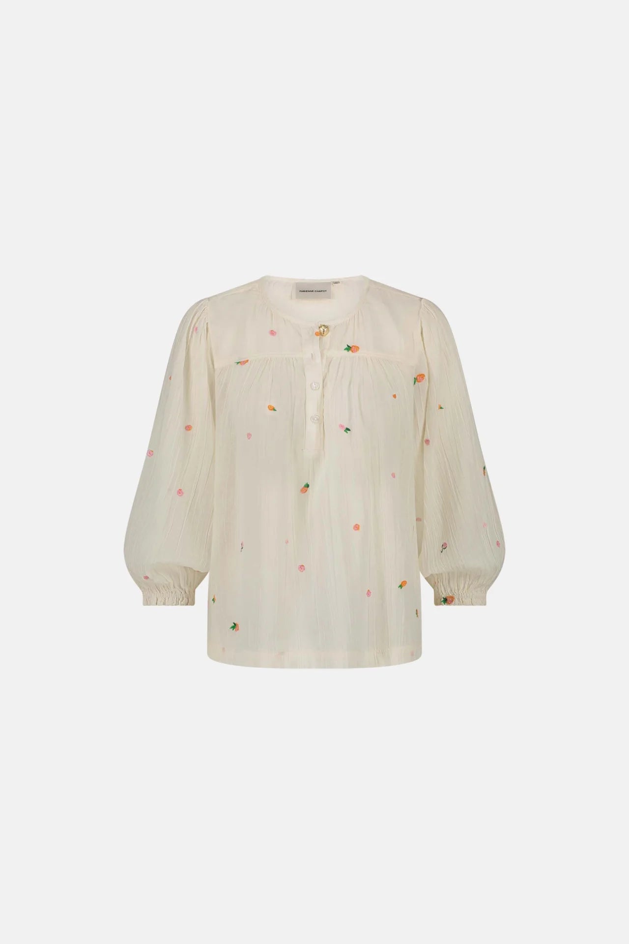 The Bindi Top by Fabienne Chapot features a cosy white hue with puffed three-quarter sleeves, vibrant embroidered flowers, and a charming buttoned neckline.