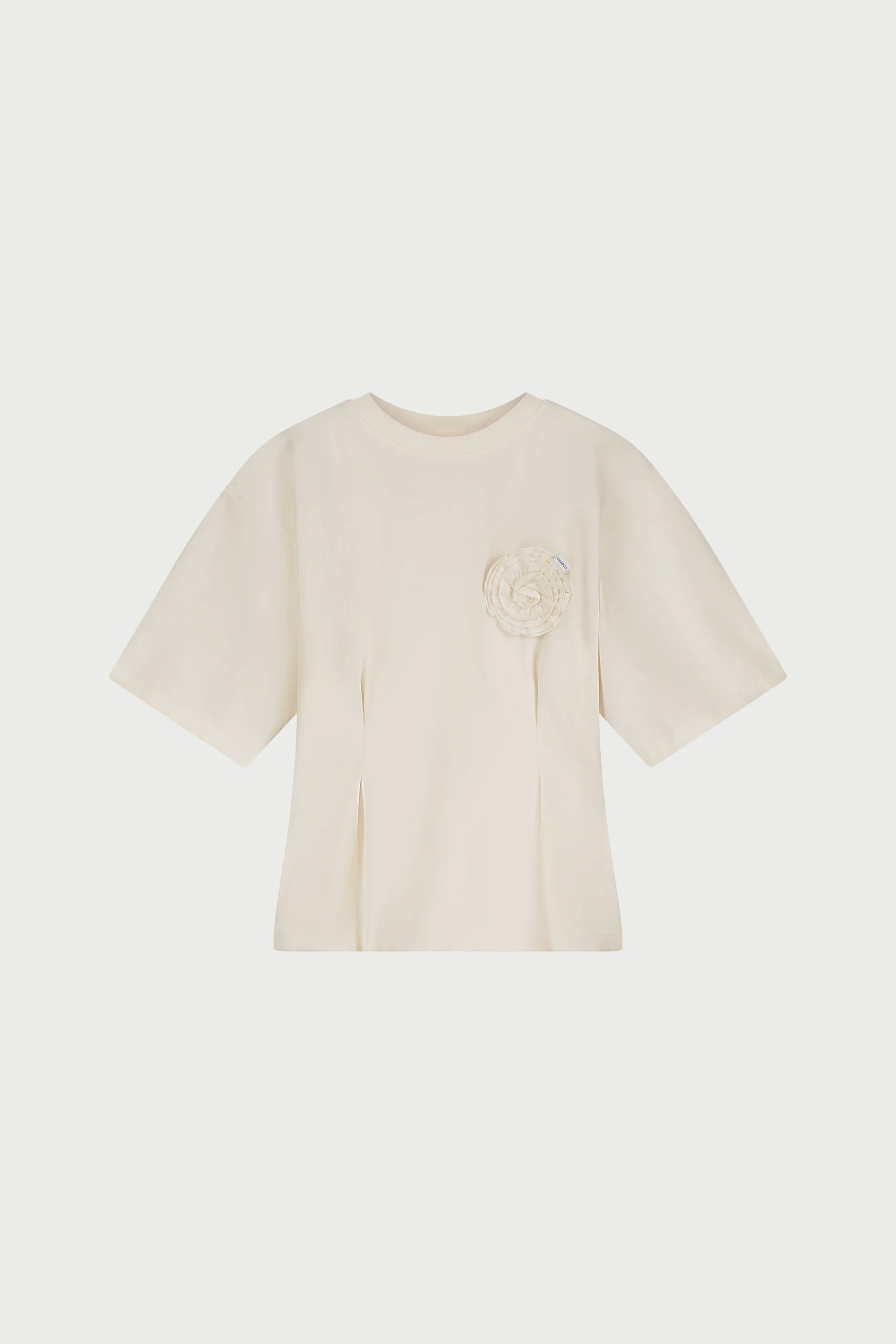 The Asta T-shirt - Cosy White by Fabienne Chapot is a cream-colored modern fitted tee crafted from organic cotton, with a round neckline and a fabric floral accent on the left chest.