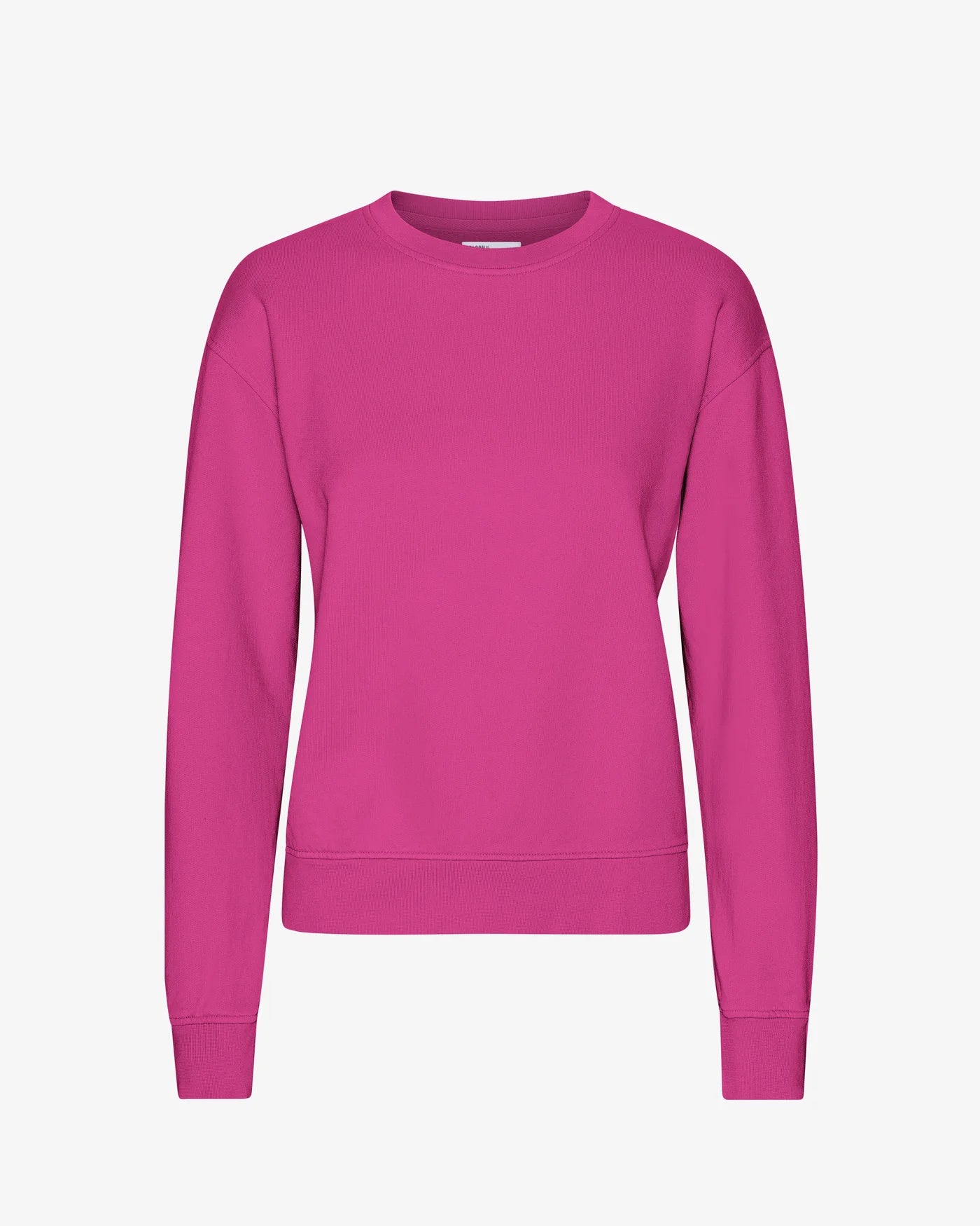 The Classic Organic Crew by Colorful Standard is a bright pink, plain long-sleeved, crew neck sweatshirt set against a white background. It's crafted from organic cotton and offers the benefits of being both machine washable and anti-pilling.