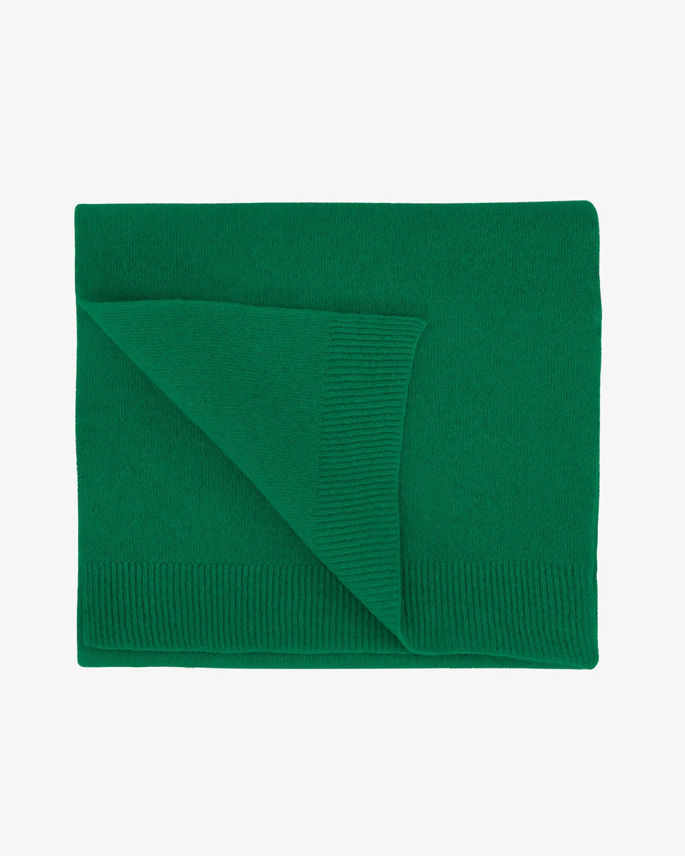 The Colorful Standard Merino Wool Scarf, shown folded on a white background, is green with ribbed edges and made from recycled merino wool.