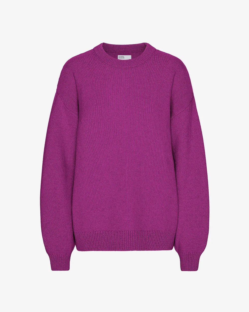 The Oversized Merino Wool Crew in Magenta Blaze by Colorful Standard is a purple knit sweater made from Merino wool, featuring a round neckline and long sleeves for a relaxed fit.