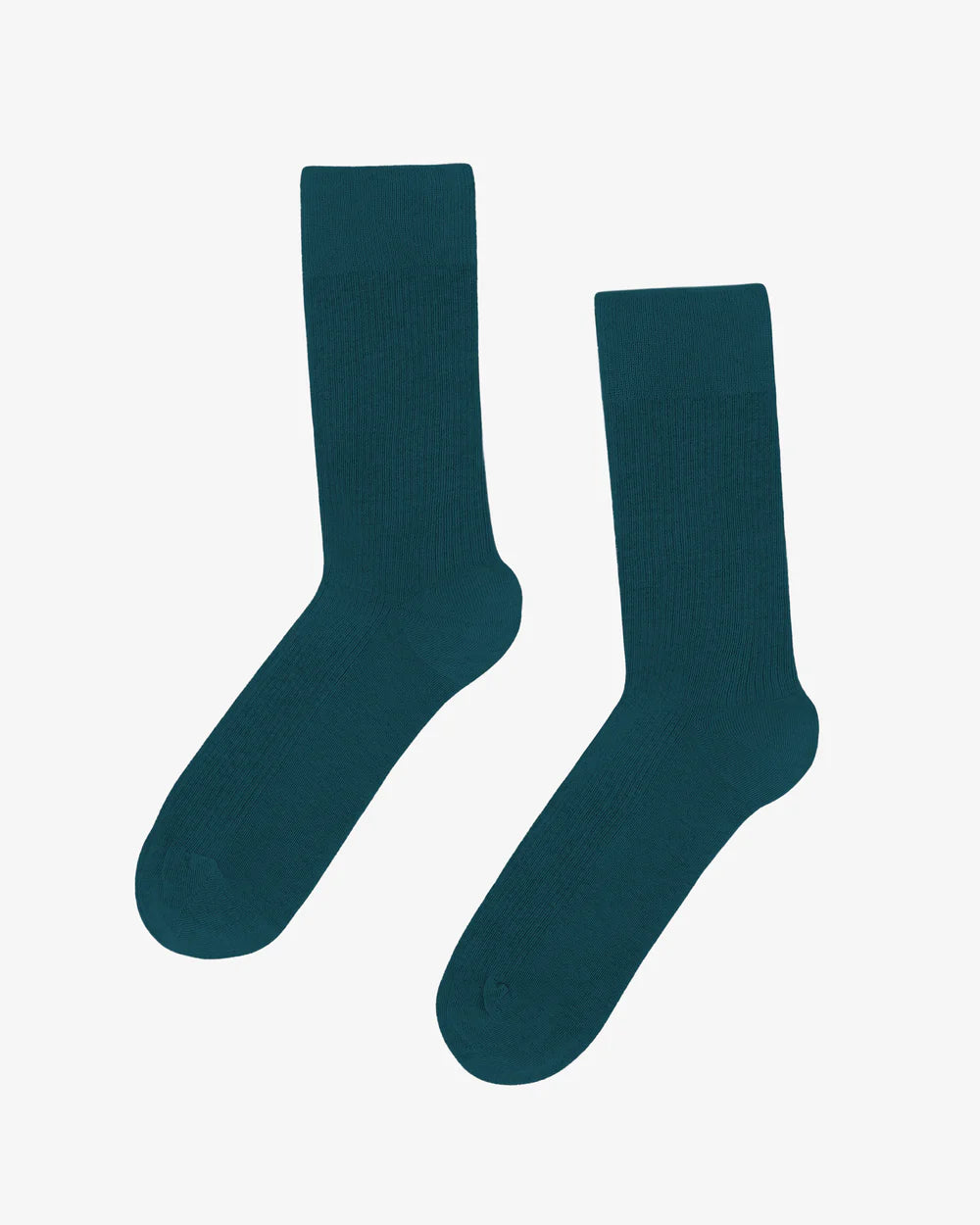 The Classic Organic Sock by Colorful Standard, made from breathable organic cotton, is showcased in dark green against a plain white background.