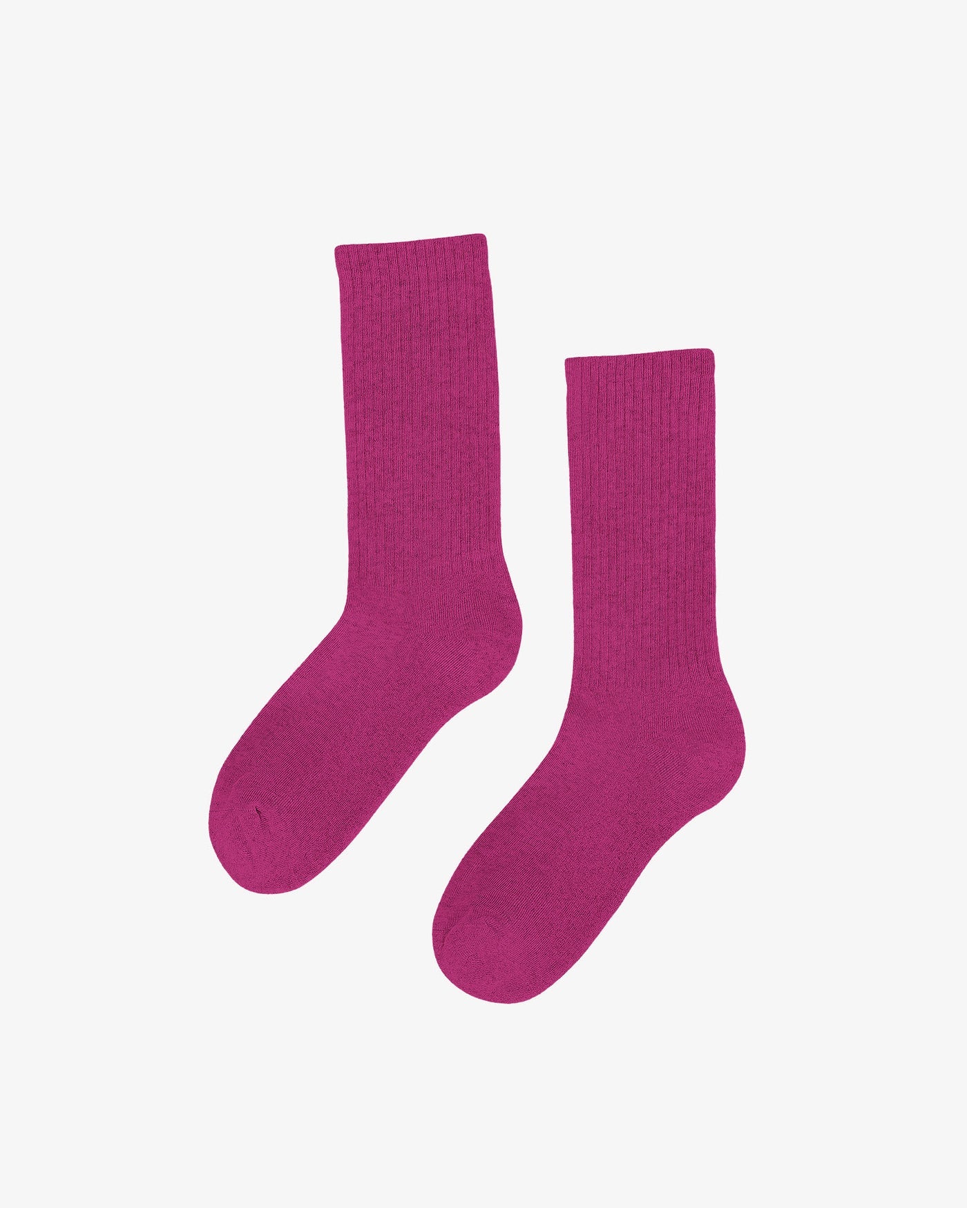 A pair of Colorful Standard's Organic Active Socks in magenta, celebrated for their comfort and sustainability, lie flat against a plain white background.