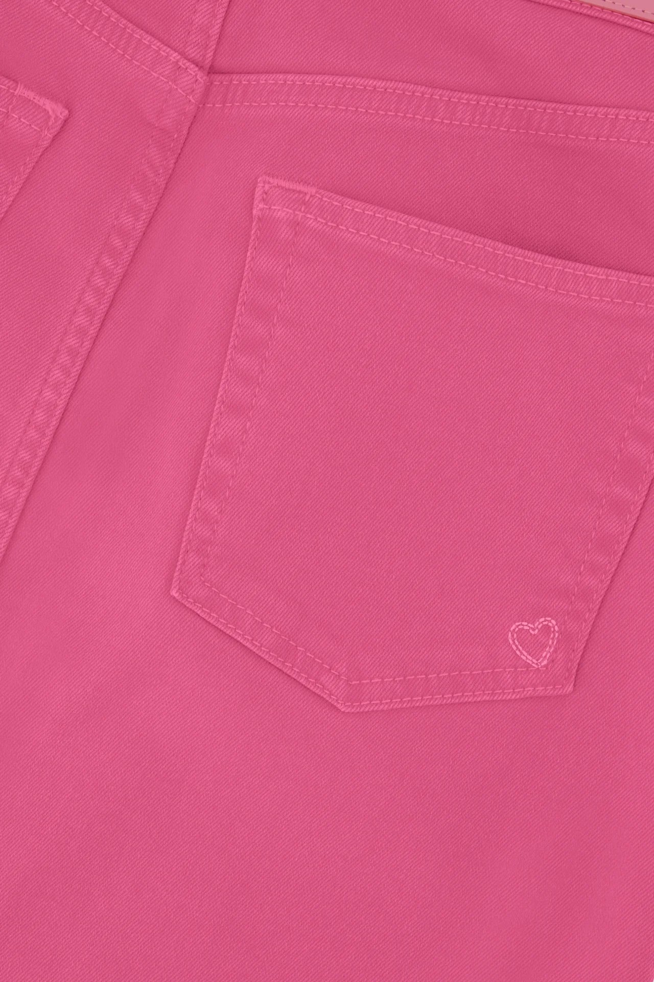 Close-up of a Hot Pink Carlyne Skirt texture with a pocket and a small heart embroidery by Fabienne Chapot.
