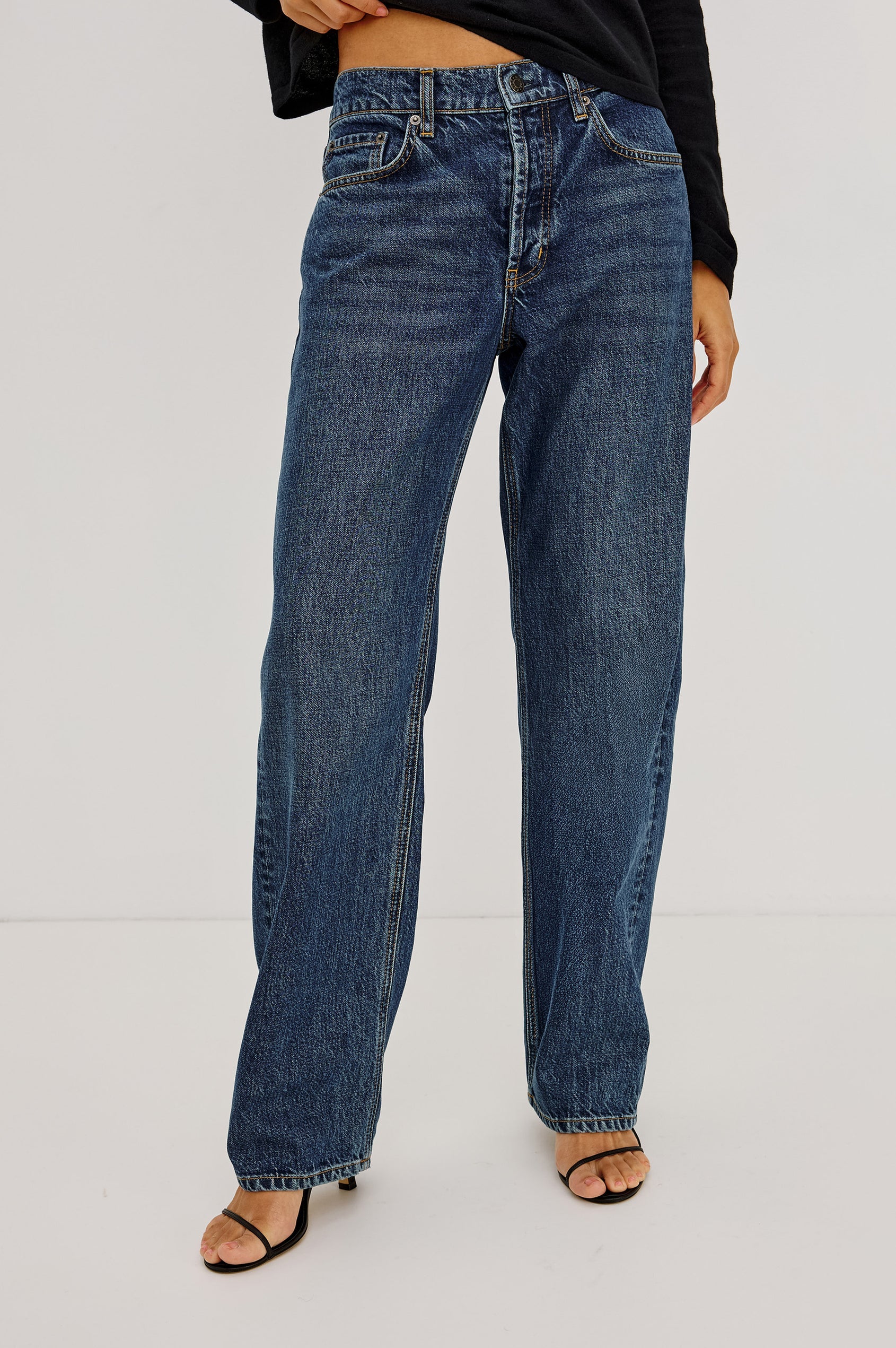 Wearing The Del Mar - Upstream relaxed wide-leg jeans by Rails and black heeled sandals, this person stands against a plain white background.