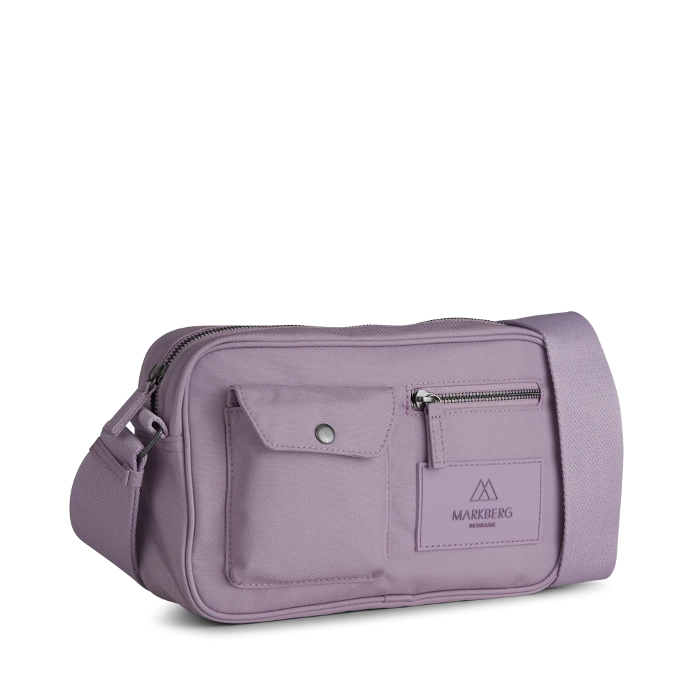 Darla Crossbody Bag - Polar Purple by Markberg, a lavender-colored vegan crossbody bag with an adjustable strap and front zipper pocket.