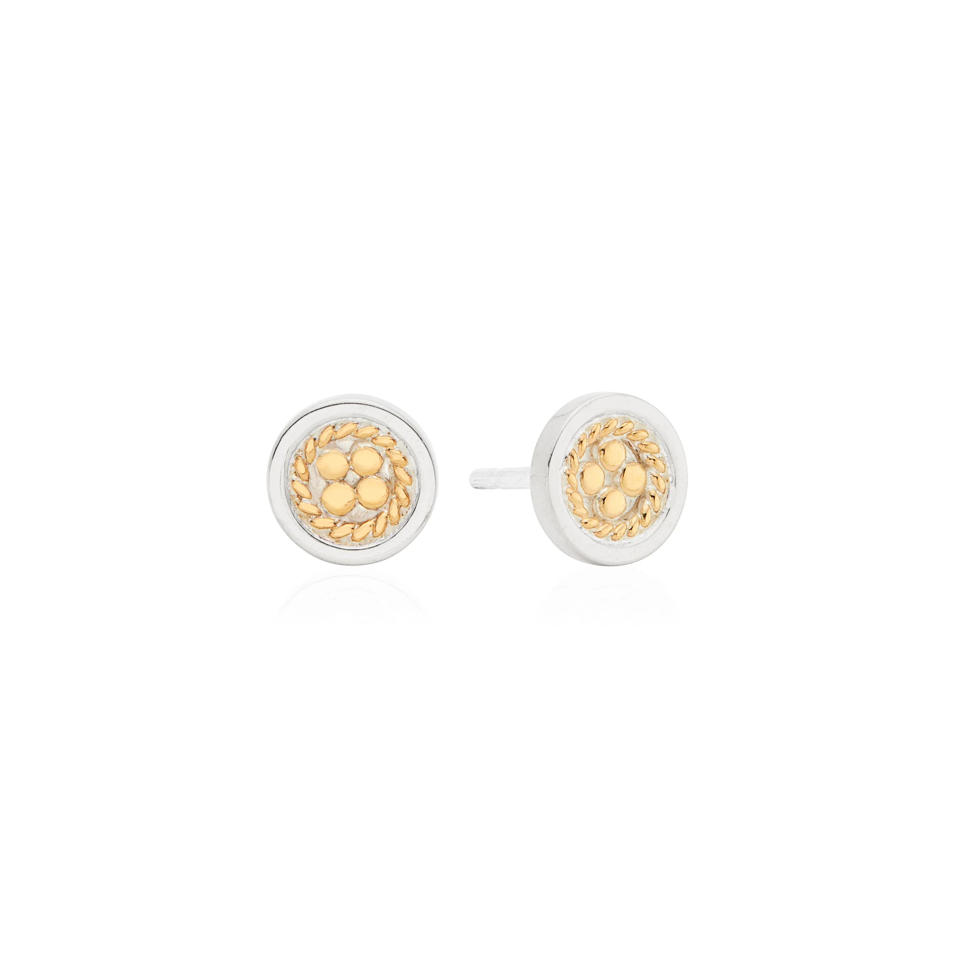Anna Beck Circle Stud Earrings: round sterling silver studs with a silver rim and gold-tone floral braided center, inspired by Bali jewelry, shown on a white background.