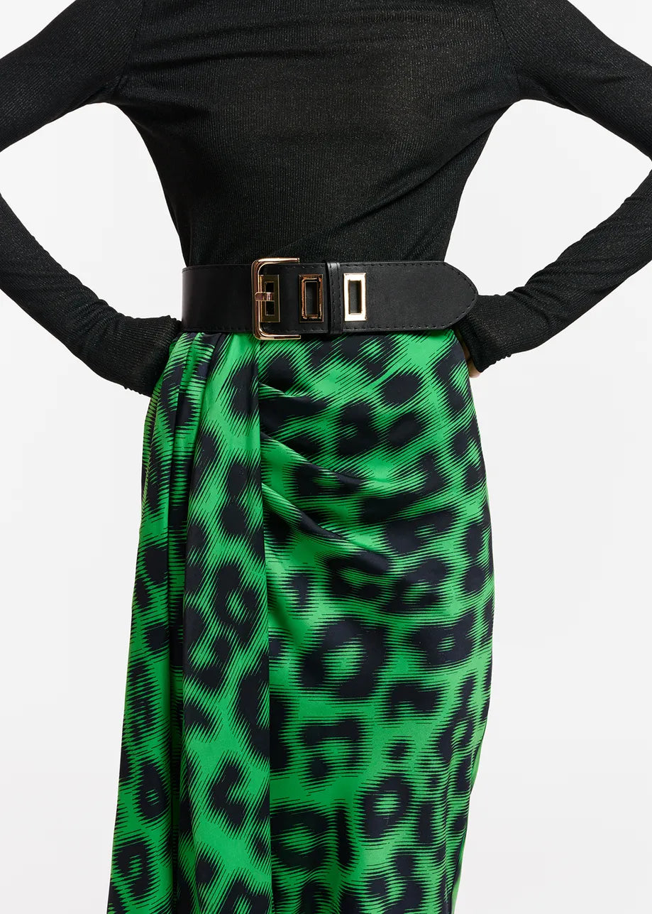 A woman wearing an Essentiel Antwerp Everest Skirt - Green made from recycled polyester-blend fabric.