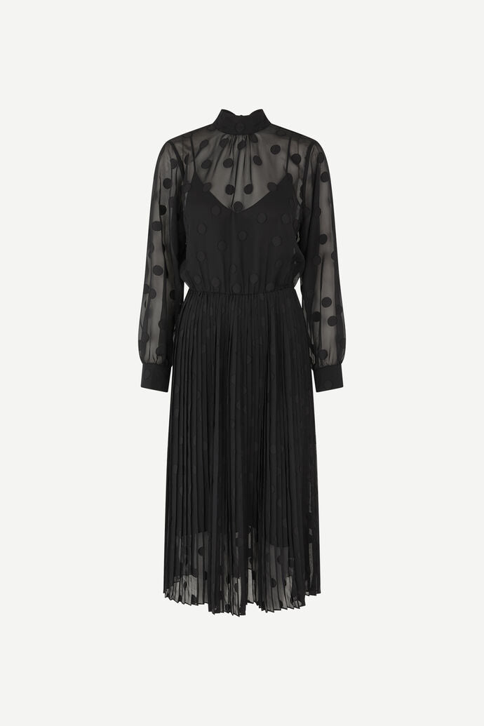 A Samsøe Samsøe Valentin Dress in Black, with sheer sleeves.