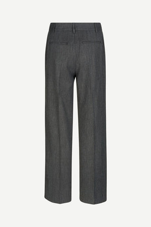 Long, dark grey Samsoe Samsoe trousers with pleated front. Back view.
