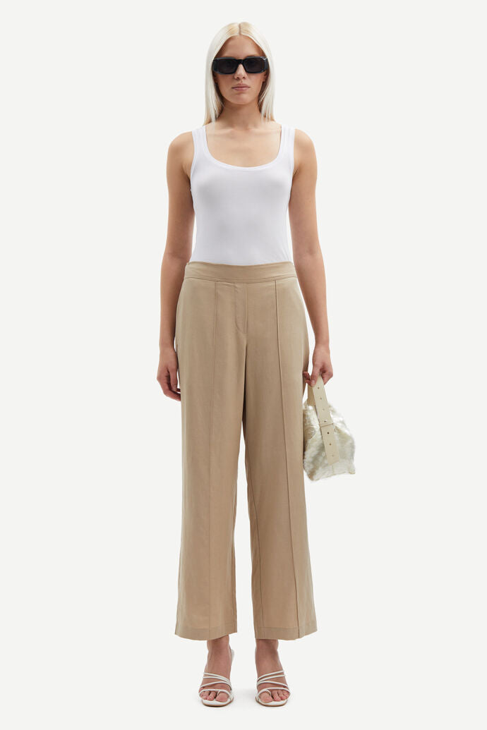 Beige high waisted tailored trousers. Ankle length.