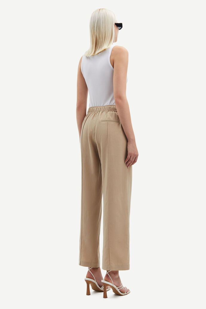 Beige high waisted tailored trousers. Ankle length.