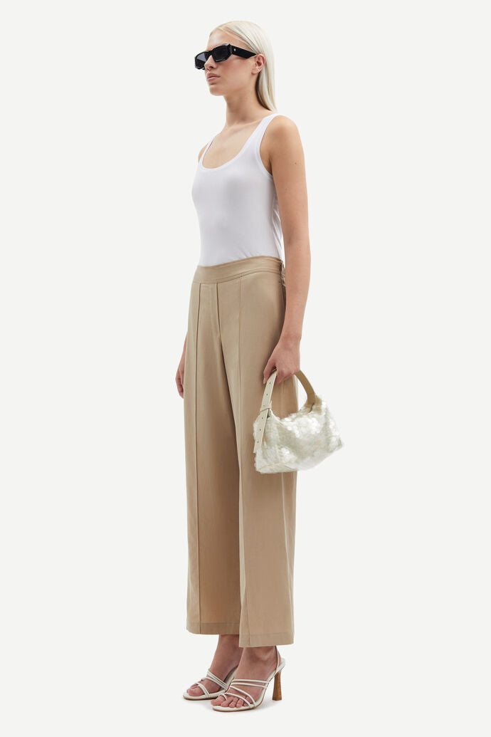 Beige high waisted tailored trousers. Ankle length.