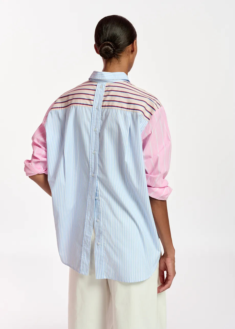 Model wears striped shirt in pink, blue, red and beige