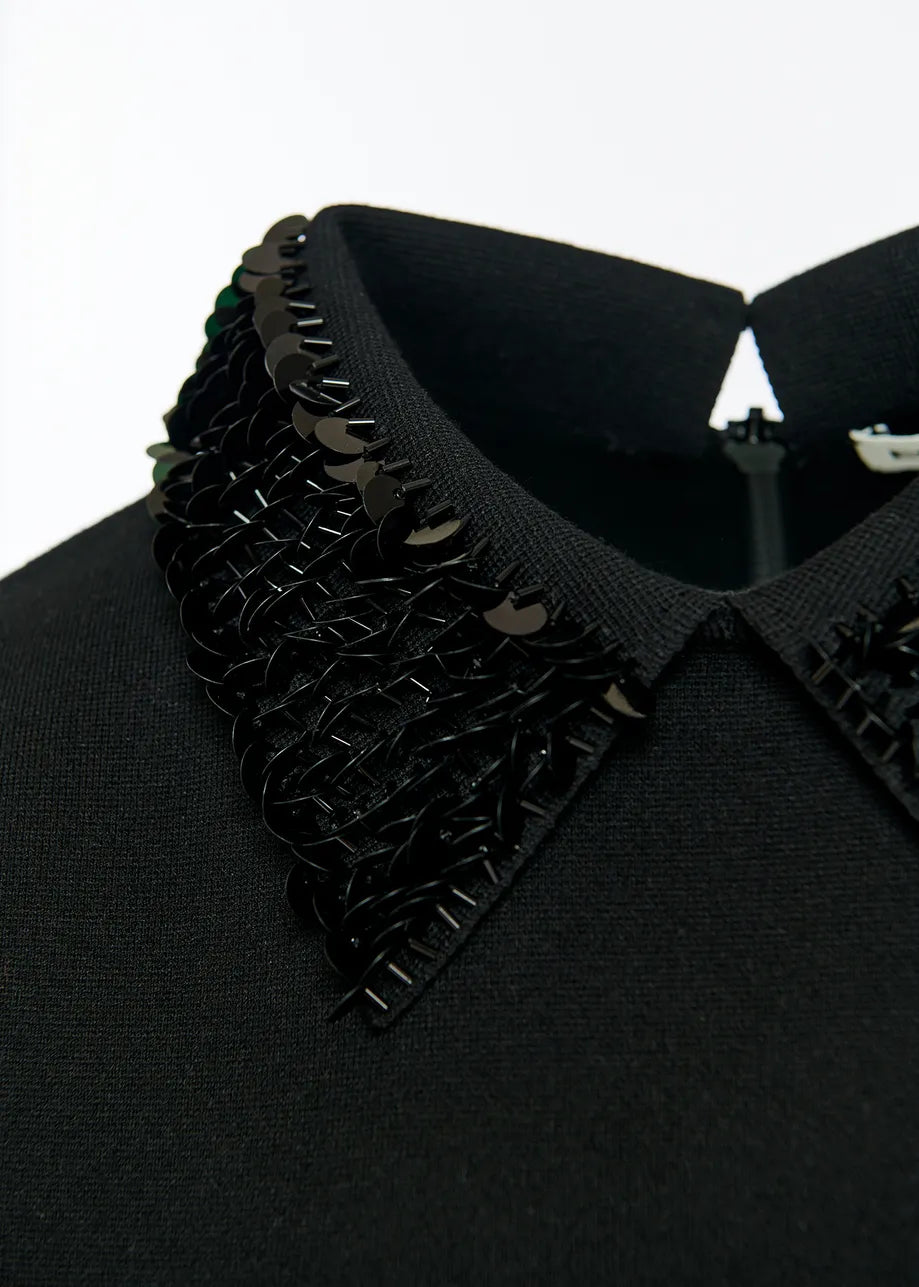 Black short sleeved top with sequined collar