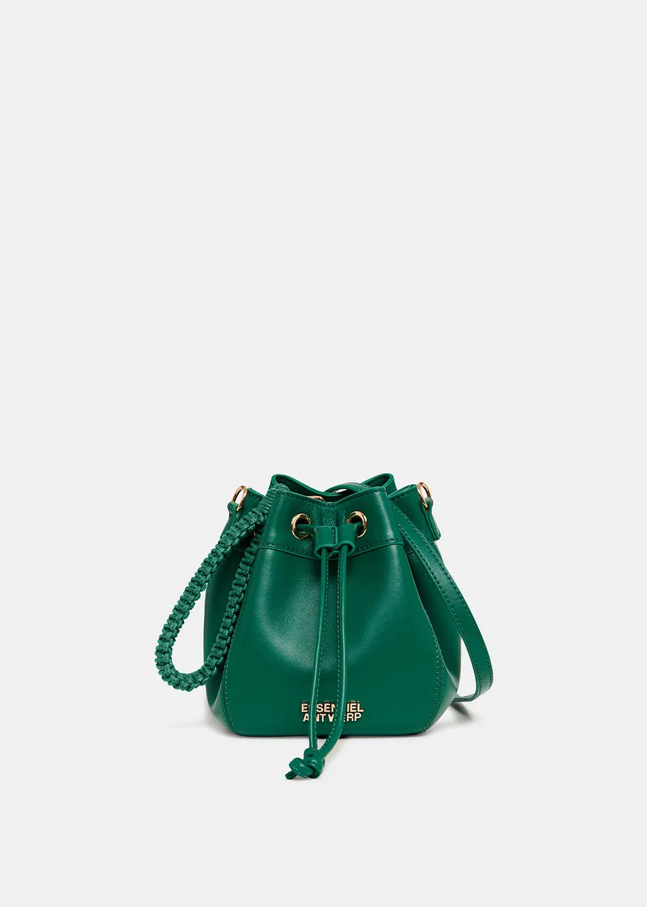 The Gabi Bag - Dark Green by Essentiel Antwerp is a compact leather bucket bag with a drawstring closure and a macramé-woven strap.