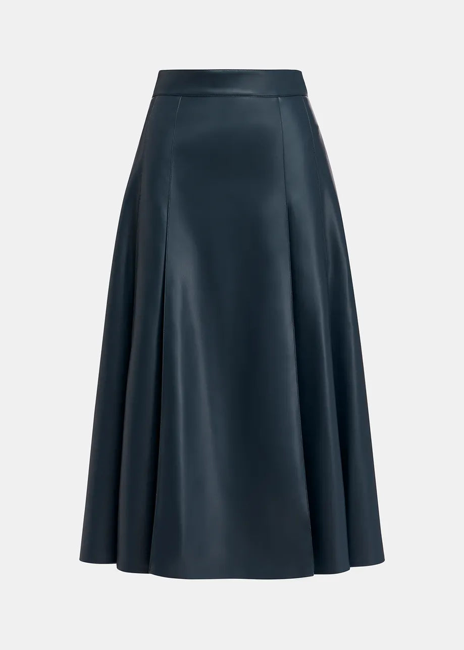 The Geeuw Faux Leather Skirt - Navy by Essentiel Antwerp is a dark blue, knee-length A-line skirt made of smooth, shiny faux leather with vertical seams; displayed against a plain white background.