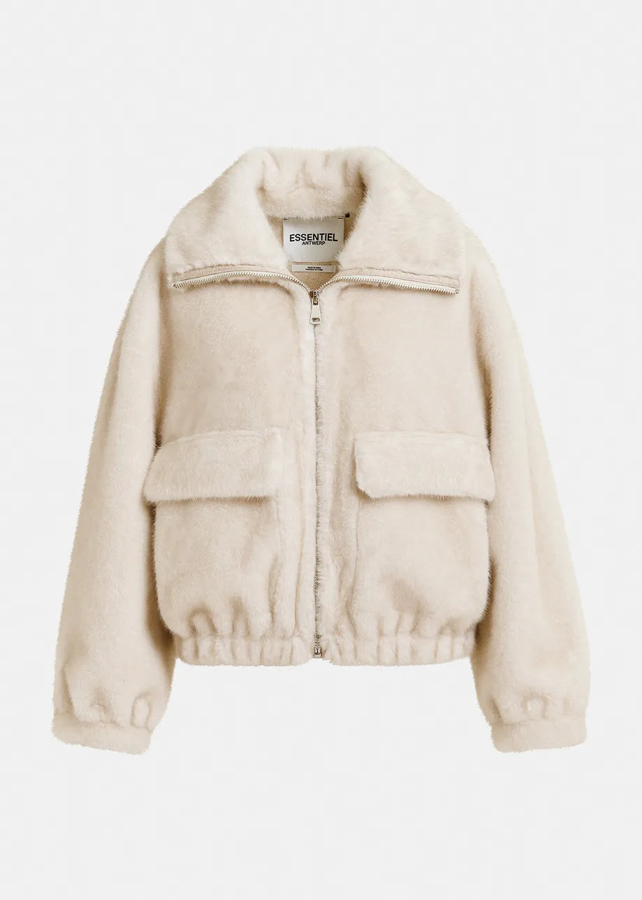 A white, faux fur jacket with an oversized bomber silhouette, front zipper, and two large flap pockets. The label reads "Essentiel Antwerp." This is the Genz Faux Fur Bomber Jacket.