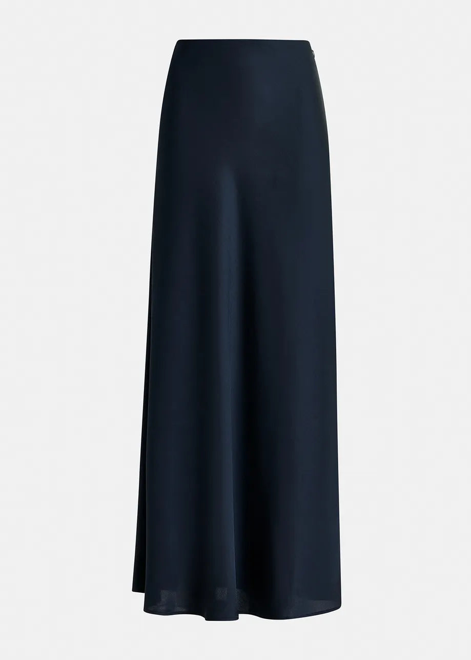 A long, navy blue Giada Satin Maxi Skirt by Essentiel Antwerp, made from a recycled polyester-blend satin with a smooth, flowing fabric, shown against a plain light background.