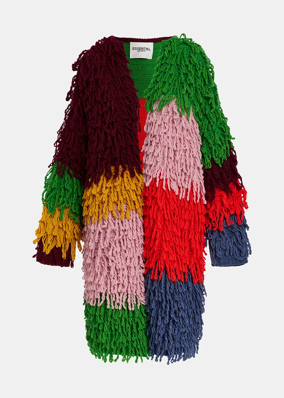 The Gingle Oversized Knit – Multicolour by Essentiel Antwerp is a multi-colored shaggy knit coat with a patchwork design, featuring sections in red, green, blue, yellow, and pink. The oversized outerwear showcases a loop-stitch knit texture and bears the label "ESSENTIEL.