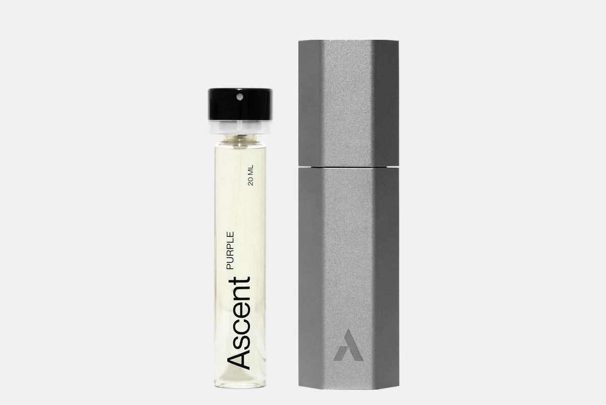 An Ascent Starter Pack - Purple 20 ml glass vial of perfume extract next to a grey hexagonal metal case.