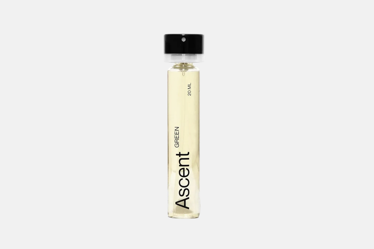 A cylindrical 20 ml Ascent Refillable Perfume - Green spray bottle with a black cap.