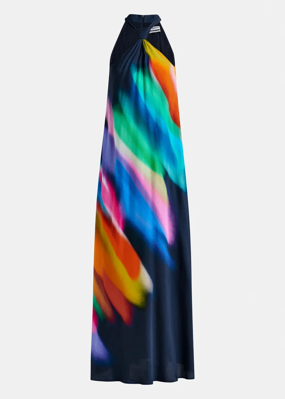 The Halinki Halterneck Dress by Essentiel Antwerp is a sleeveless dark maxi dress featuring a vibrant color pattern with diagonal multicolored streaks of blue, green, orange, pink, and purple.