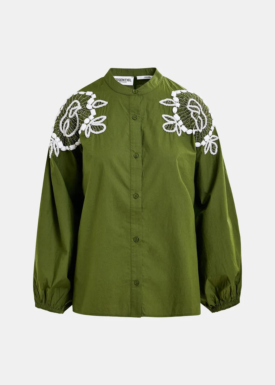 The Hementine Shirt in green by Essentiel Antwerp is a long-sleeve button-up blouse with white floral embroidery on the shoulders, blouson sleeves, a round collar, and elastic cuffs.