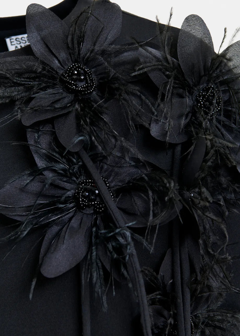 Close-up of the Ibiscus T-shirt in black by Essentiel Antwerp, showcasing large 3D floral embellishments with bead and feather details.
