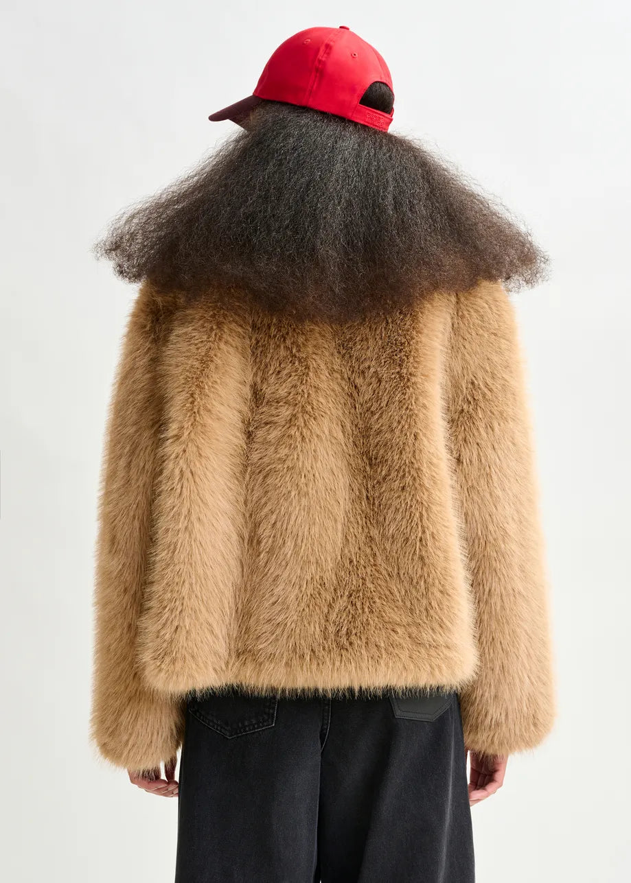 Person wearing a red baseball cap, black jeans, and the Ijacket Faux Fur Jacket - Brown by Essentiel Antwerp, shown from the back against a plain light background.