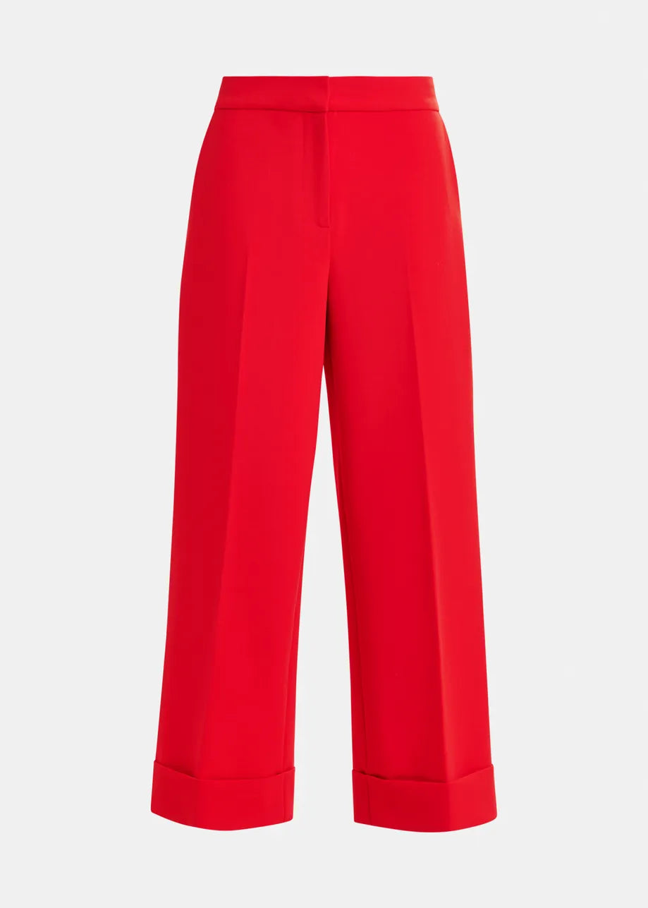 The Imo Cropped Trousers by Essentiel Antwerp feature a bright red color, flared leg, cuffed hem, and front creases, shown against a plain white background.