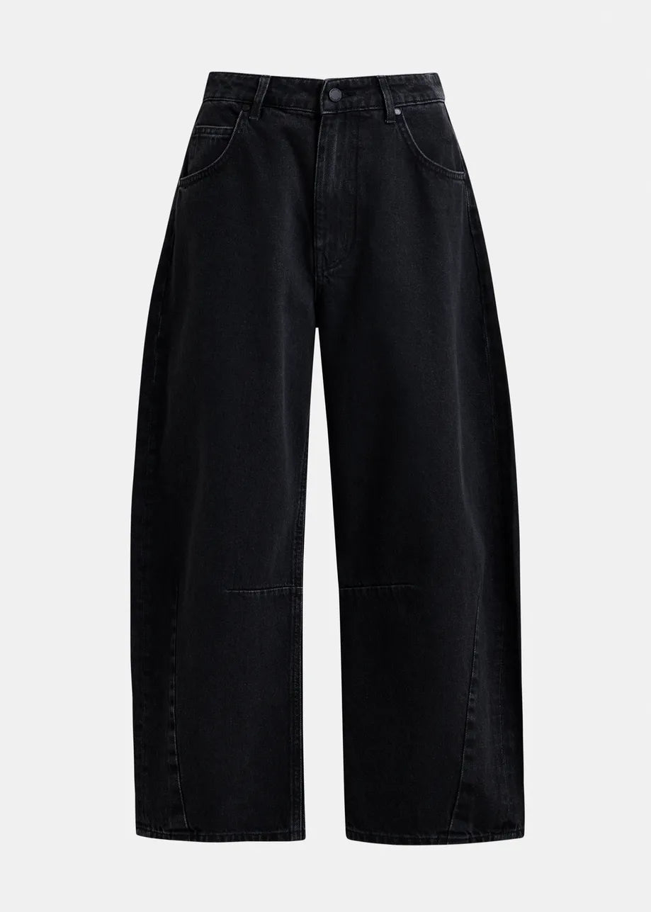 The Essentiel Antwerp Interstellar Barrel Leg Jeans in black feature a wide-leg silhouette, organic cotton fabric, front and back pockets, belt loops, and a button-zipper closure, shown against a plain light background.