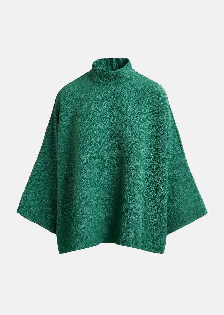 The Iscratch Oversized Top by Essentiel Antwerp is a green kimono-inspired piece with wide sleeves and a short mock neck, crafted from recycled polyester and shown on a plain white background.