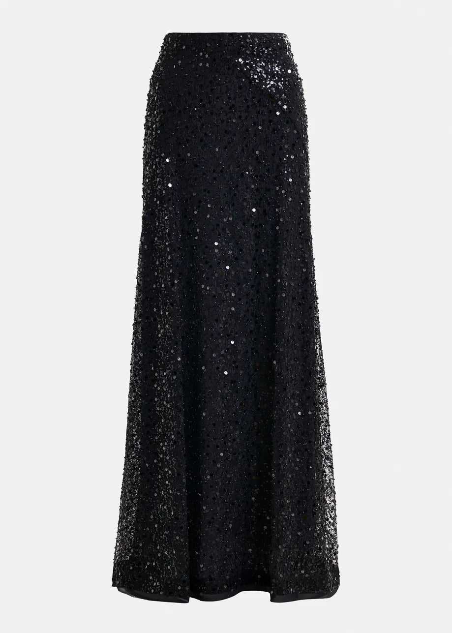 The Isequin Embellished Maxi Skirt by Essentiel Antwerp is a black maxi skirt with a fitted waist and flared hem, shown against a plain white background.