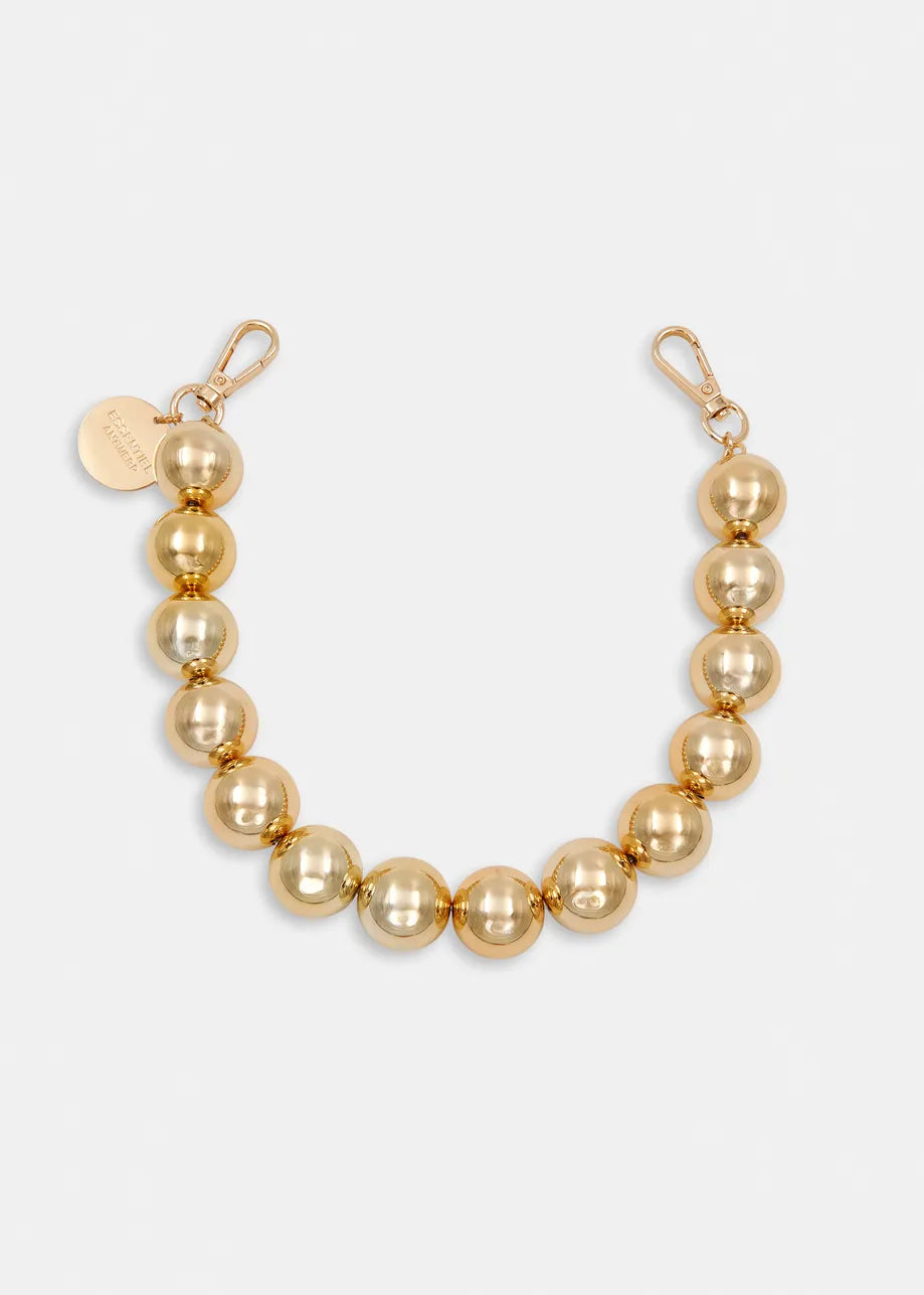 The Jadine Gold Tone Necklace by Essentiel Antwerp features bold metallic-tone beads, dual lobster clasps, and an engraved round tag—a versatile statement piece for any outfit.