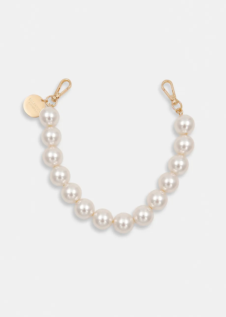 The Essentiel Antwerp Jadine Gold Tone Necklace - Pearl is a short strand of white pearls with gold clasps and a round gold tag, displayed on a plain white background.