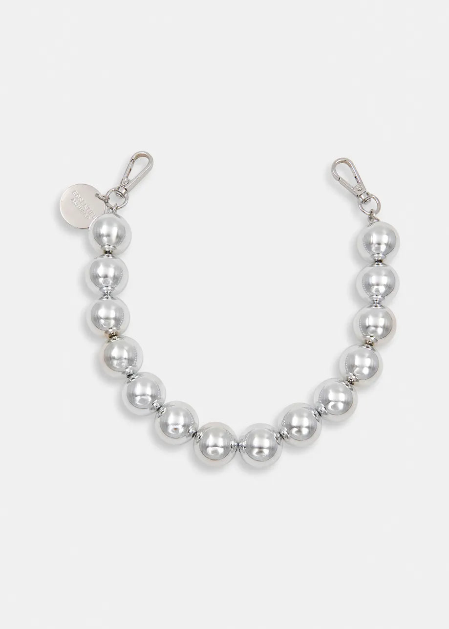 The Jadine Beaded Necklace - Silver by Essentiel Antwerp features metallic-tone beads, metal clasps at both ends, and a round tag—ideal as versatile jewelry or a statement piece.