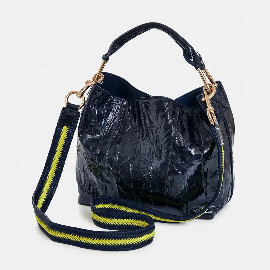 Essentiel Antwerp navyy patent leather handbag with yellow zipper on a white background