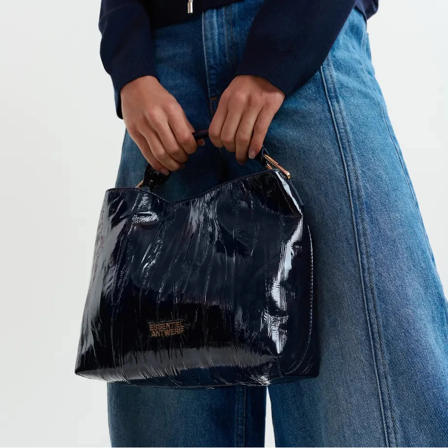 Essentiel Antwerp navyy patent leather handbag with yellow zipper on a white background