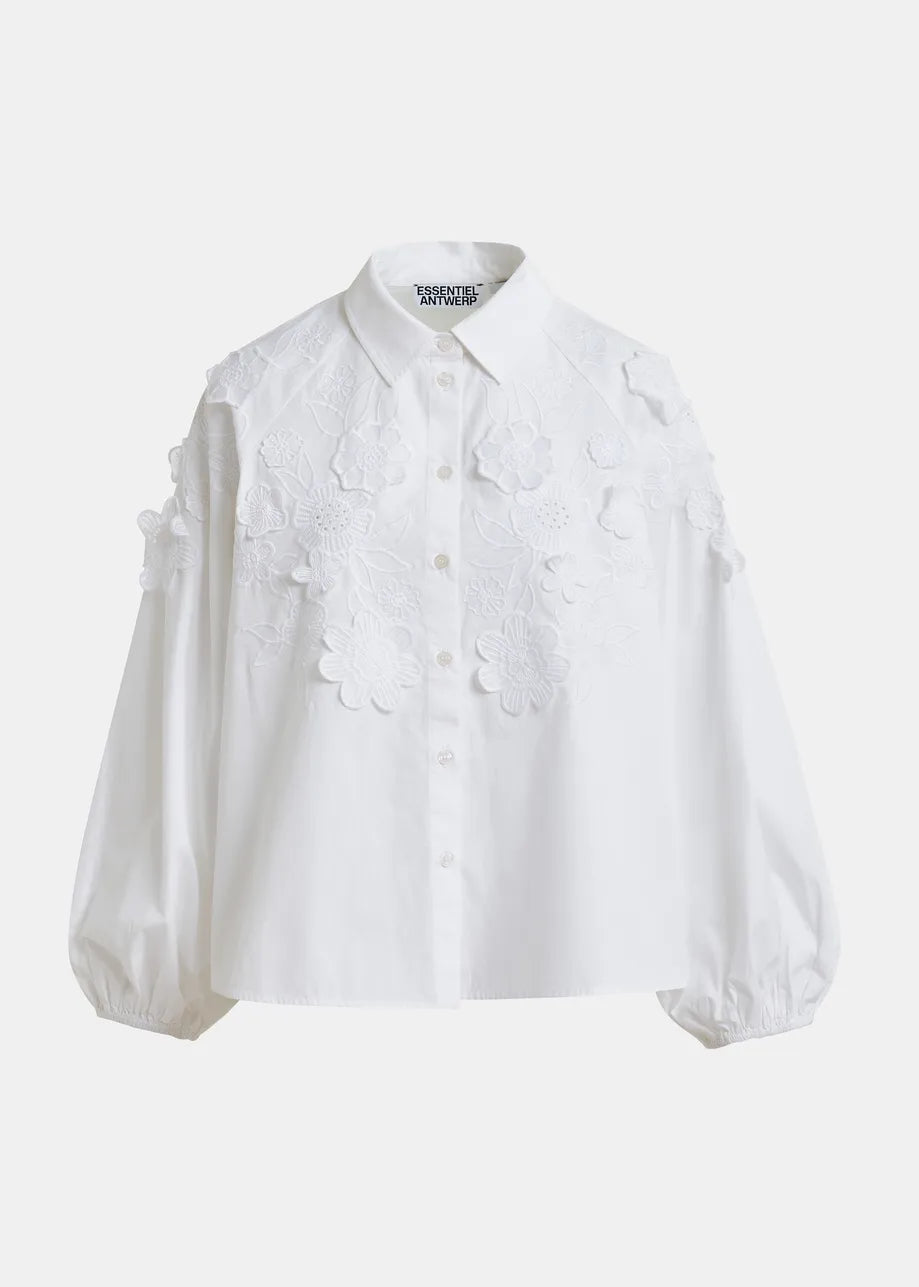 The Joella Cotton Flower Shirt in white by Essentiel Antwerp features floral embroidery on the front and shoulders, a classic collar, gathered cuffs, and subtle balloon sleeves for a stylish touch.