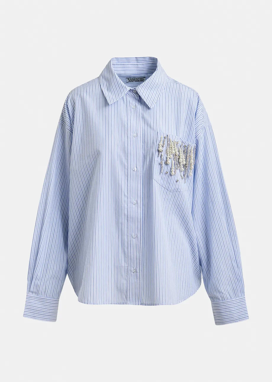 The Jommeke Embellished Shirt - Blue Stripe by Essentiel Antwerp features an oversized fit, long sleeves, blue and white stripes, and a chest pocket with embellishment for a playful touch.