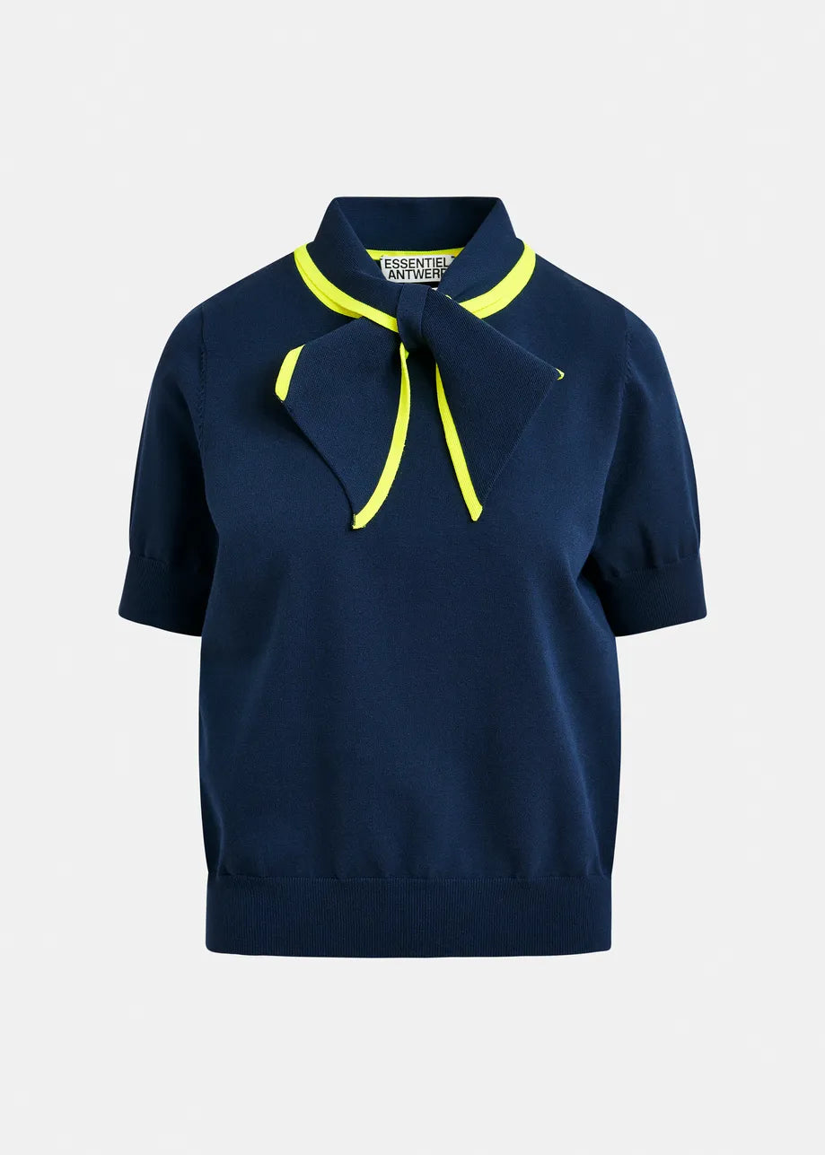 The Jonda Knit Polo by Essentiel Antwerp features a relaxed navy fit with short sleeves, a large neck bow, and neon yellow trim along the collar and bow edges.